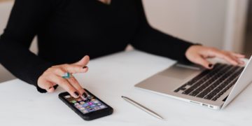 Photo by Karolina Grabowska: https://www.pexels.com/photo/crop-woman-using-smartphone-and-laptop-during-work-in-office-4467737/