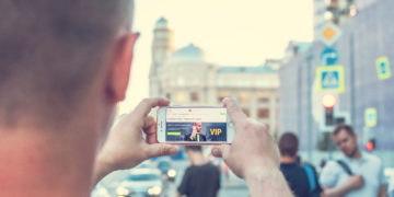 Photo by Artem Beliaikin from Pexels: https://www.pexels.com/photo/man-standing-near-outdoor-while-holding-white-smartphone-2433163/