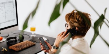 Photo by Karolina Grabowska: https://www.pexels.com/photo/busy-female-talking-on-smartphone-and-checking-messages-during-work-in-contemporary-office-4476635/