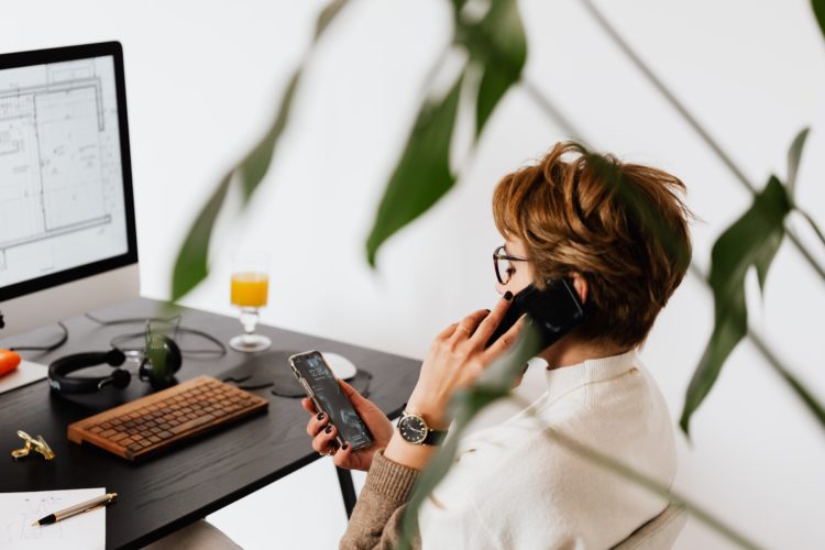 Photo by Karolina Grabowska: https://www.pexels.com/photo/busy-female-talking-on-smartphone-and-checking-messages-during-work-in-contemporary-office-4476635/