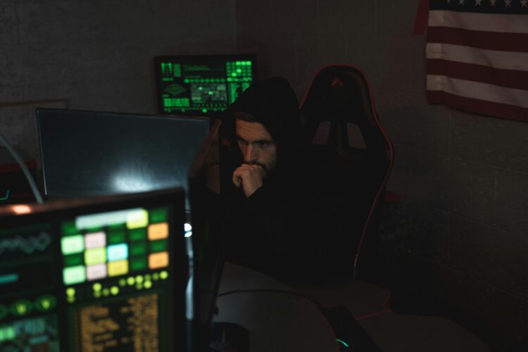 Photo by Tima Miroshnichenko: https://www.pexels.com/photo/man-in-black-hoodie-sitting-on-chair-looking-at-computer-monitor-5380585/